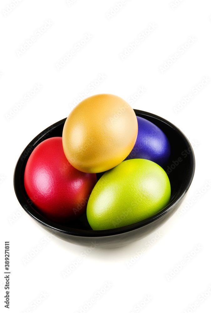 Group of colored Easter Eggs in saucer on white background. A bunch of pearl colored easter eggs in black saucer isolated on white with shadow. Studio shot. Group of colored Easter Eggs in saucer on white background. A bunch of pearl colored easter eggs in black saucer isolated on white with shadow. Studio shot.