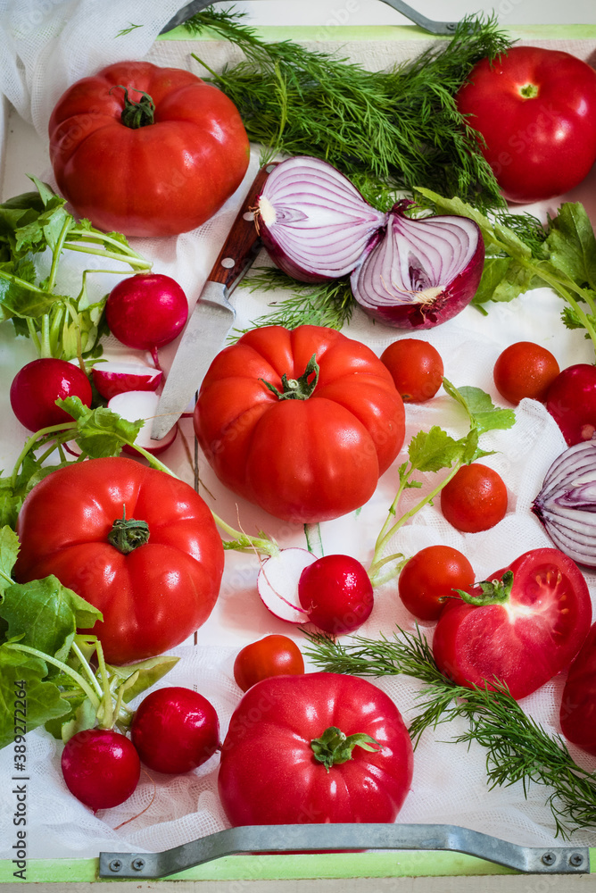 Fresh vegetables in white box. Tomatoes, red onion, radish, and dill. Fresh vegetables in white box. Tomatoes, red onion, radish, and dill.