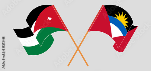 Crossed and waving flags of Antigua and Barbuda and Jordan