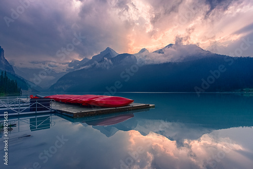 Beautiful foggy sunset over lake in summer. Lake Louise, Banff National park, Alberta, Canada