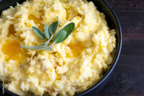 Fényképezés Mashed Potatoes Topped With Butter and Sage Leaves: Mashed Yukon gold potatoes w