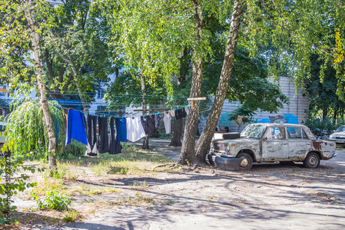 Clothes dry on a rope in the courtyard of tall houses. Ropes and clothespins near houses in the city