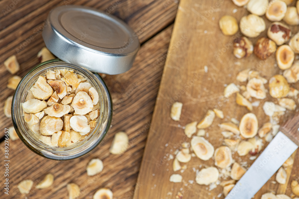 Fototapeta premium Portion of freshly chopped Hazelnuts (close up; selective focus)