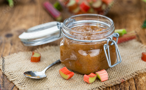 Rhubarb Jam on an old wooden table (close up shot; selective focus)
