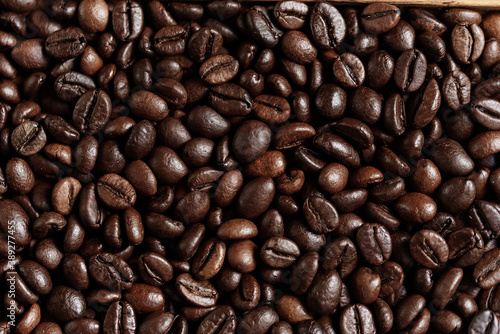 closeup of perfect Roasted coffee beans background. Food ingredients, top view, space for text. Soft selective focus.