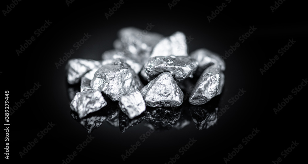 Heap of silver nuggets isolated on black background