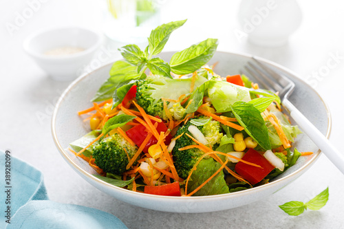 Fresh raw vegetable salad with boiled broccoli, greens and vegetables