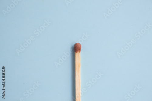  Match on a blue background close-up. Minimalism concept, pastel colors. Top view, flat lay