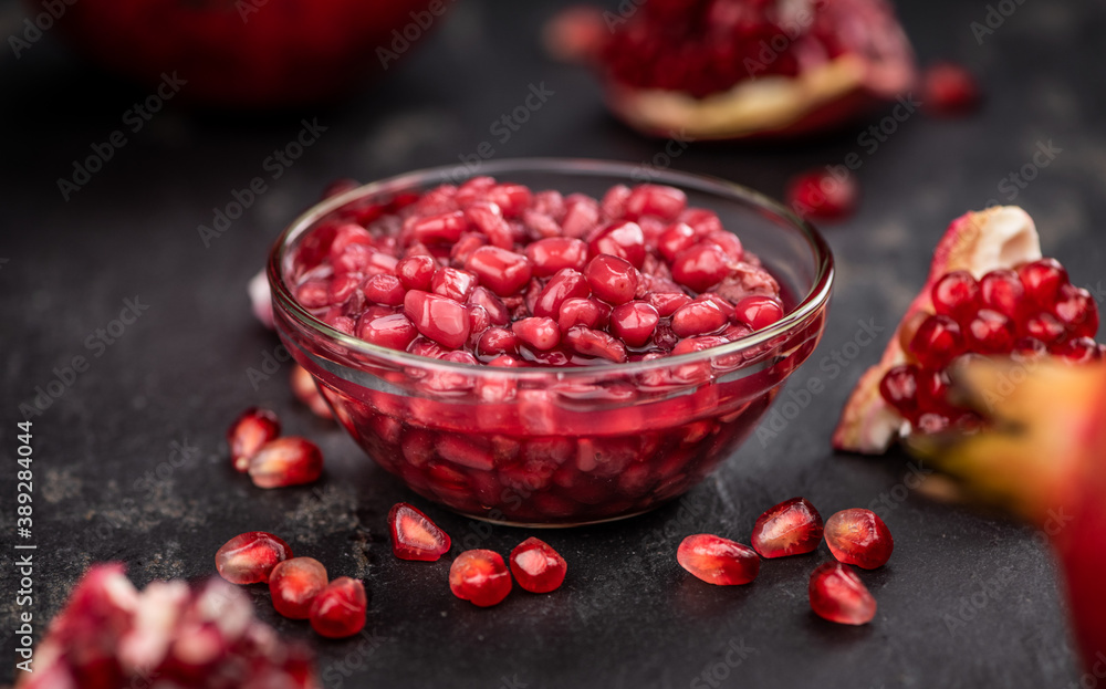 Fresh made preserved Pomegranate seeds on a slate slab (close-up shot; selective focus) Fresh made preserved Pomegranate seeds on a slate slab (close-up shot; selective focus)