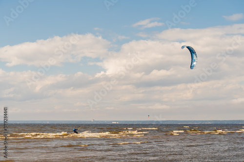 The kitesurfer is riding on the waves of the Bay.