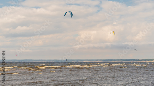 The kitesurfer is riding on the waves of the Bay.