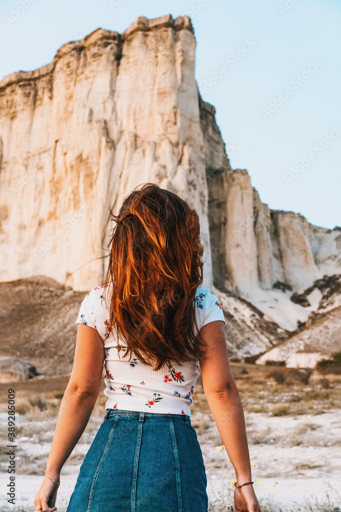 Portrait of a charming woman in a skirt at sunset on a White rock background in Crimea Portrait of a charming woman in a skirt at sunset on a White rock background in Crimea