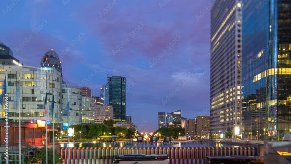 Paris cityscape with modern buildings in business district La Defense day to night transition timelapse. Glass facade skyscrapers. Arc de Triomphe with Champs Elysees on background. Concept of Paris cityscape with modern buildings in business district La Defense day to night transition timelapse. Glass facade skyscrapers. Arc de Triomphe with Champs Elysees on background. Concept of