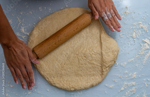 Woman rolling pin dough