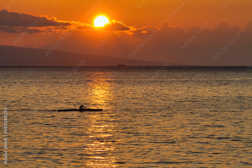 Lone kayaker rowing quickly across the ocean on Maui. Lone kayaker rowing quickly across the ocean on Maui.