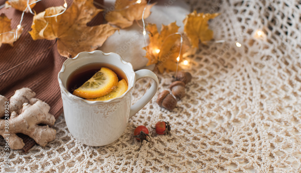 Cup of warm tea fall style, fall scene with leaves, lights and acorns, cozy autumn aesthetic concept Cup of warm tea fall style, fall scene with leaves, lights and acorns, cozy autumn aesthetic concept