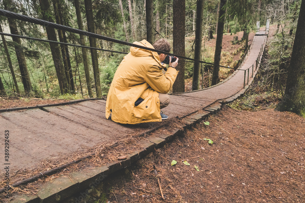 photographer traveler on a suspension bridge in forest wild extreme journey photographer traveler on a suspension bridge in forest wild extreme journey