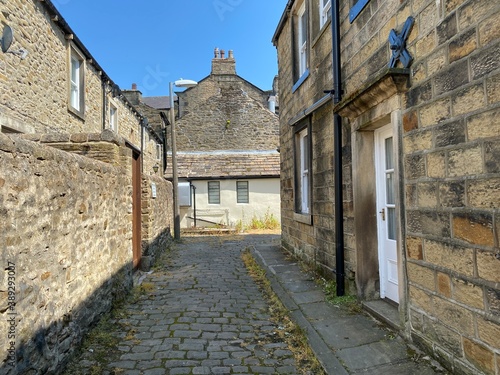 Stone cobbled back street, near Hallam's Yard, Skipton, UK photo