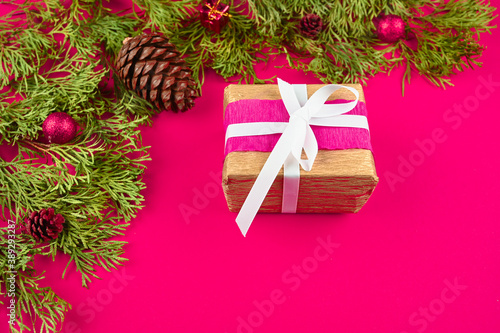 gift wrap on pink background with christmas decoration