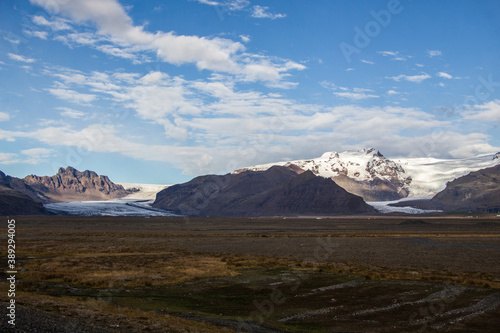 SKAFTAFELL NATIONAL PARK  ICELAND - SEPTEMBER 19  2018  view of Skaftafell glaciers from the road. Snow and mountains in the background of a vast field.