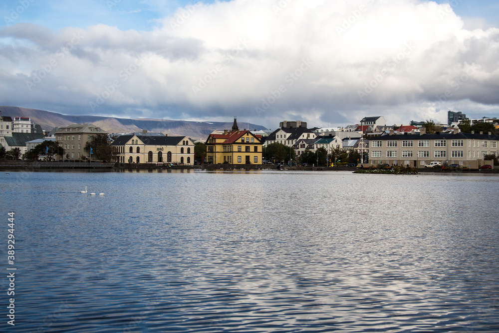 LAKE TJÖRNIN, REYKJAVIK, ICELAND - SEPTEMBER 18, 2018: View of lake Tjörnin and cityscape with buildings and houses.