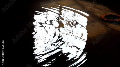 A window's reflection in a flooded basement of an abandoned building	