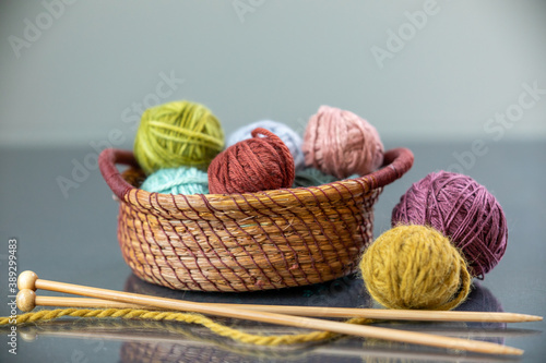 knitting yarn and knitting needles in a pine needle basket