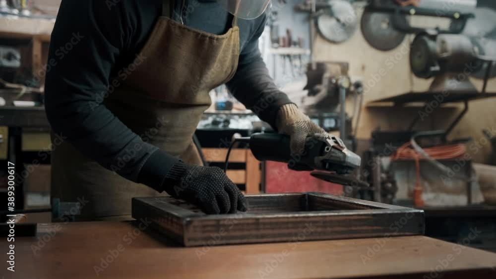 A man in gloves cuts metal with a circular saw, a lot of sparks. The working process A man in gloves cuts metal with a circular saw, a lot of sparks. The working process