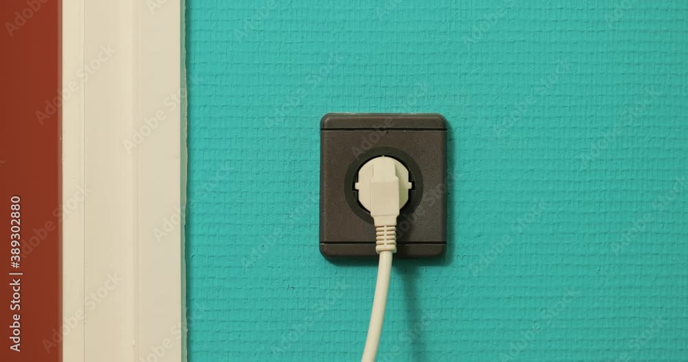 Electric outlet plugging and unplugging a power cord, European Type F