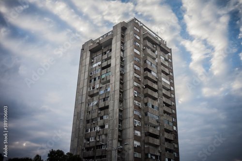 Quadro su tela Selective blur on a High rise building from Novi Beograd, in Belgrade, Serbia, a traditional communist housing ensemble with a brutalist style, with a moving sky effect in background