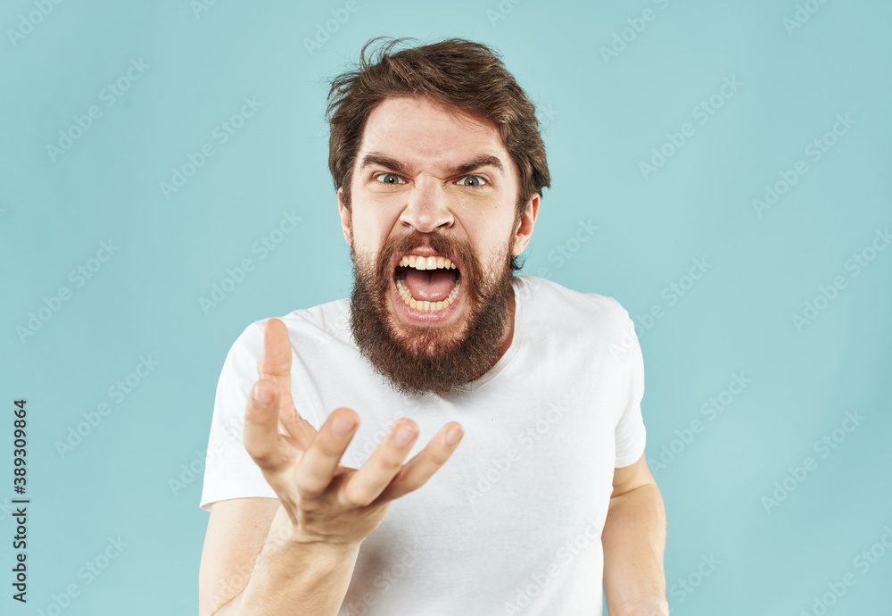 Man in t-shirt gesturing emotions irritability with his hands Man in t-shirt gesturing emotions irritability with his hands