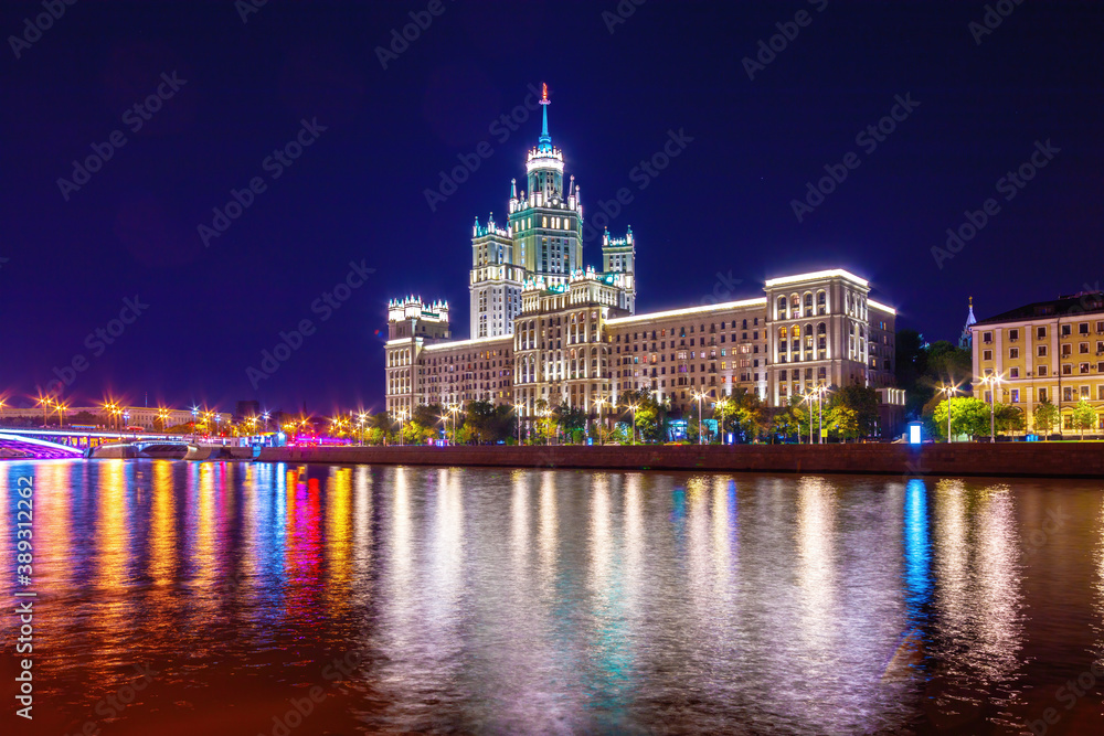 Stalin Skyscraper on Kotelnicheskaya Embankment of the Moscow River. Night shot of Moscow river reflection.