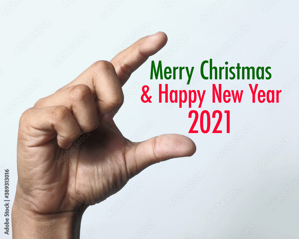 Fototapeta premium Hand showing Christmas 2021