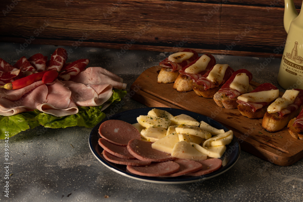 Tables of cold cuts - hams, bondiola -, cheeses and bruschetta tapas, Iberian ham and mozzarella. Tables of cold cuts - hams, bondiola -, cheeses and bruschetta tapas, Iberian ham and mozzarella.