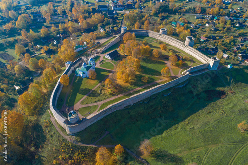Above the ancient fortress of Izborsk is ggolden autumn. Pskov region, Russia