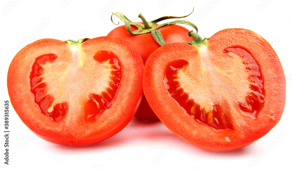 A whole red tomato cut into two halves is isolated on a white background. A whole red tomato cut into two halves is isolated on a white background.