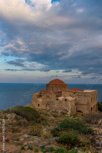 The Byzantine Church of Agia Sofia on the top of the medieval castle of Monemvasia, with view to the Aegean Sea during an amazing sunset.