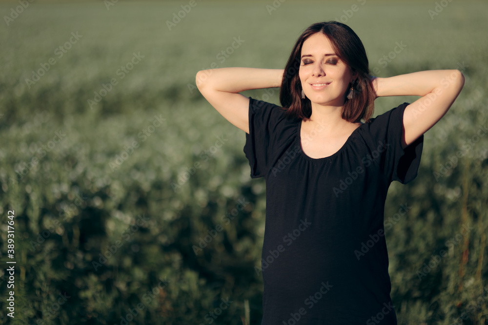 Portrait of a Beautiful Pregnant Woman Outdoors in Nature