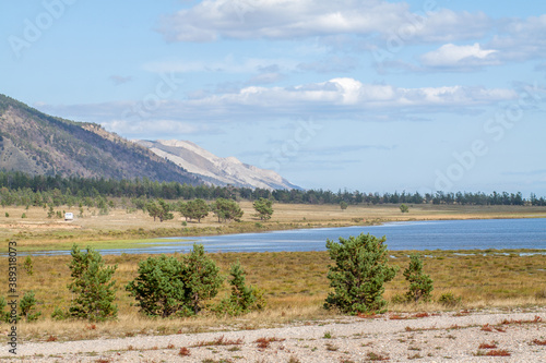 Baikal lake landscape with evegreen trees, water and mountains