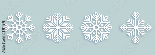 Vector set of 4 white Christmas paper cut snowflakes with shadow on white background. New year and Christmas design elements