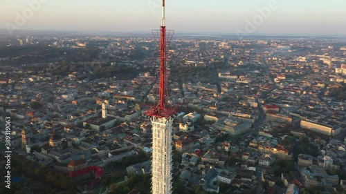 Telecommunication tower for 5g networks, on city background.