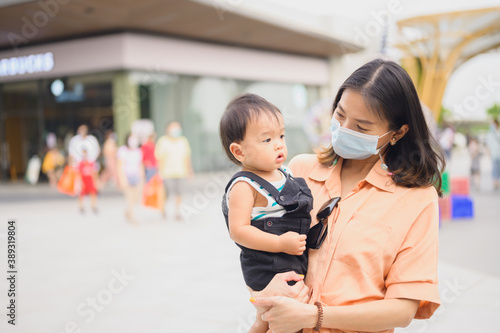 Asian women in protective sterile medical mask with her son,Air pollution, virus, coronavirus concept