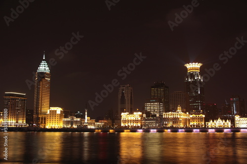 Night view of Shanghai Waitan Skyscrapers with bund center building and Guangming Finance building along Huangpu river in Shanghai, China.