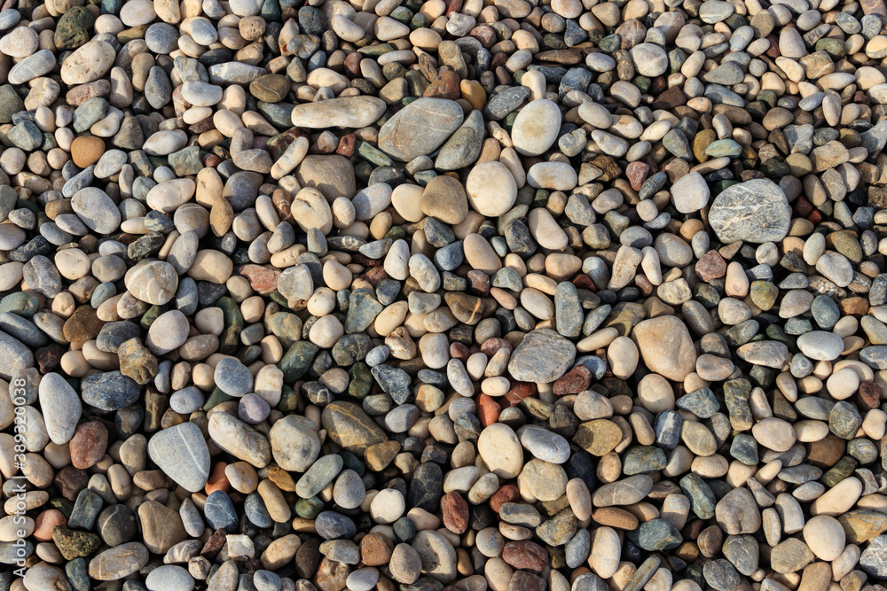 Smooth round pebbles texture background. Pebble sea beach close-up Smooth round pebbles texture background. Pebble sea beach close-up