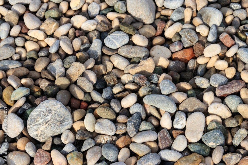 Smooth round pebbles texture background. Pebble sea beach close-up Smooth round pebbles texture background. Pebble sea beach close-up