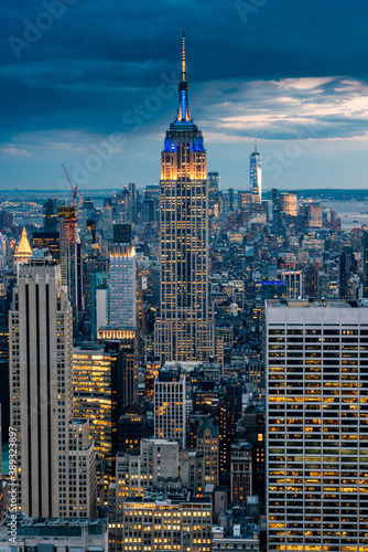Close up view of the Empire State Building and New York City skyline on a beautiful evening with city lights