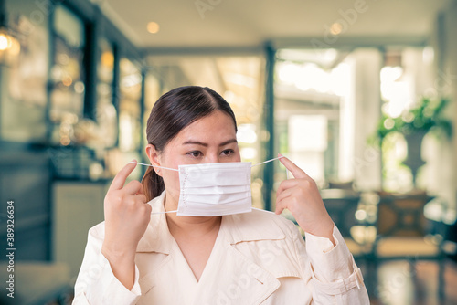 Asian women wearing surgical face mask to prevent flu disease Covid-19