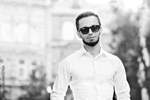 portrait of a handsome bearded guy on a city street. young man l