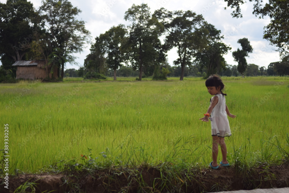 a girl playing and happy on green field