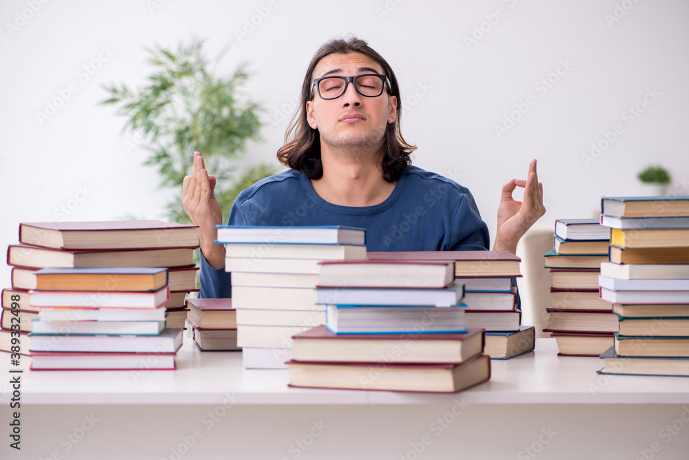 Young male student preparing for exams at home Young male student preparing for exams at home